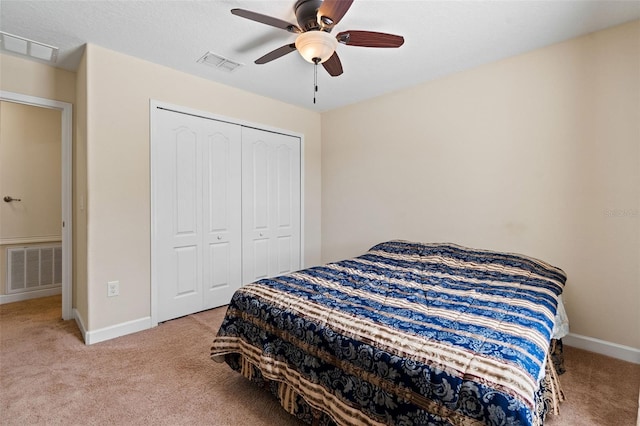 bedroom featuring carpet floors, a closet, visible vents, and baseboards