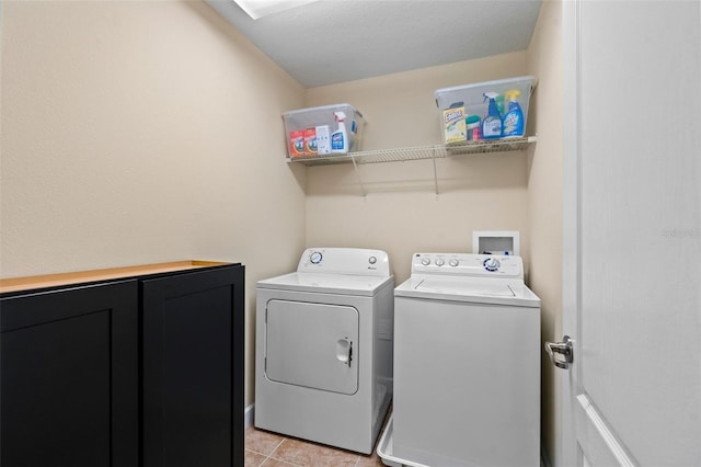 washroom featuring laundry area, separate washer and dryer, and light tile patterned flooring