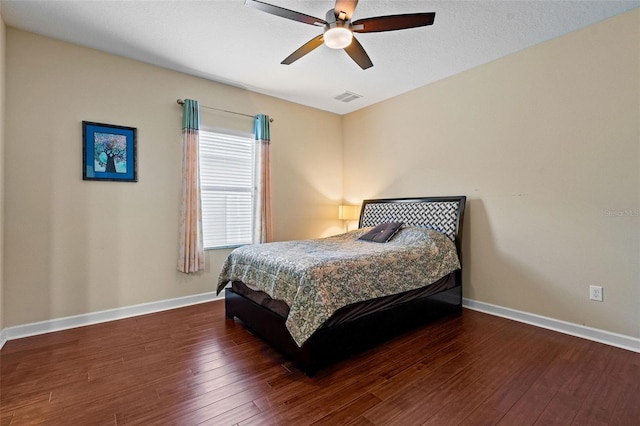 bedroom featuring wood-type flooring, visible vents, ceiling fan, and baseboards