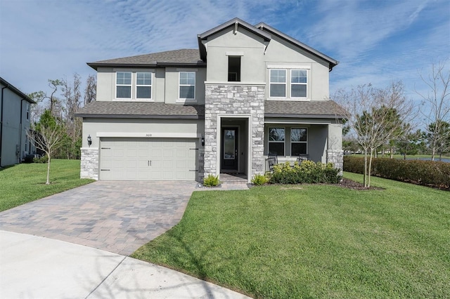 view of front of property featuring stone siding, decorative driveway, a front yard, and stucco siding