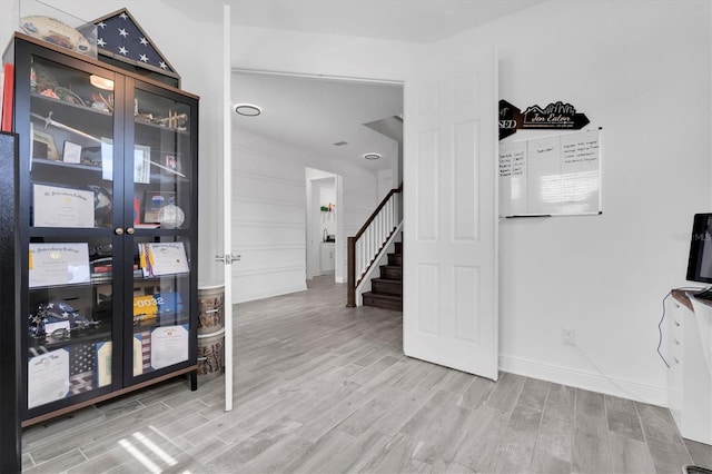 interior space featuring stairs, baseboards, and wood finish floors