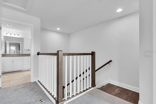 stairway with baseboards and recessed lighting