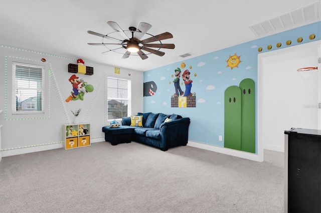 interior space featuring carpet floors, a ceiling fan, visible vents, baseboards, and wallpapered walls