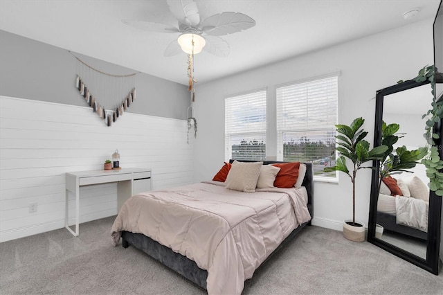 carpeted bedroom with baseboards and a ceiling fan