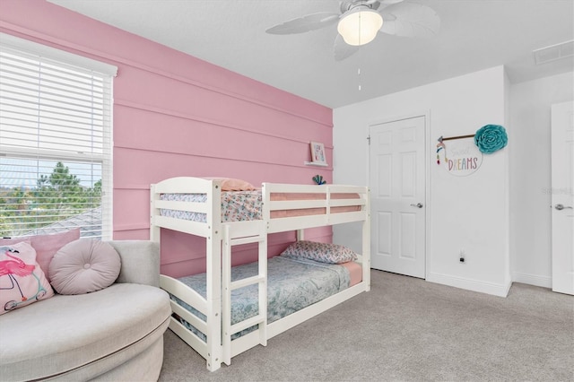 bedroom with carpet, visible vents, baseboards, and a ceiling fan