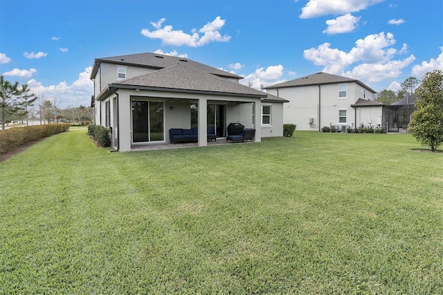 back of house with an outdoor hangout area, a shingled roof, a lawn, stucco siding, and a patio area