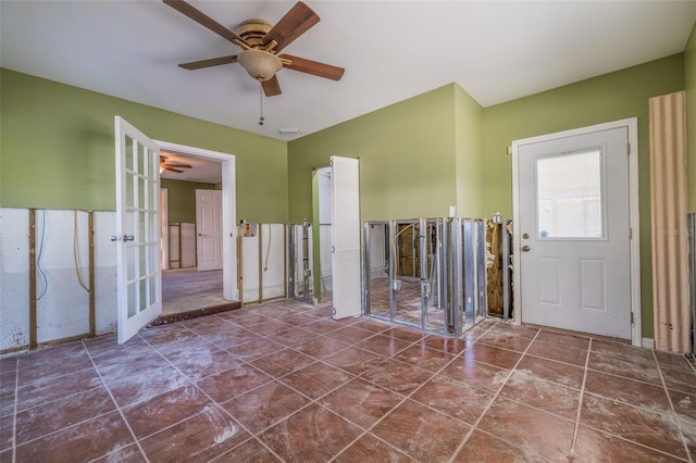 spare room with visible vents, ceiling fan, and tile patterned floors