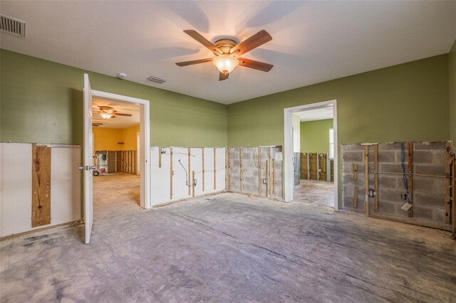 spare room featuring a ceiling fan and visible vents