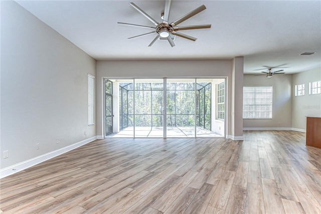 unfurnished room featuring light wood-style floors, ceiling fan, visible vents, and baseboards