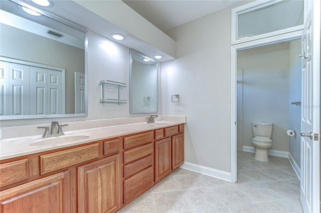 full bath featuring toilet, visible vents, a sink, and tile patterned floors