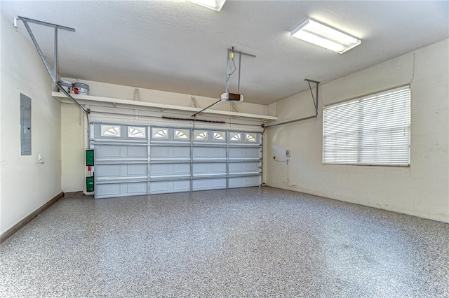 garage featuring a garage door opener, electric panel, and baseboards