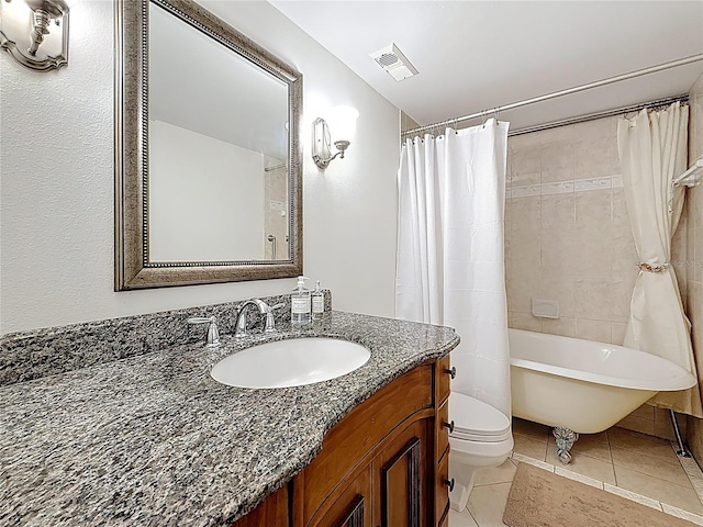 bathroom with visible vents, toilet, vanity, and tile patterned flooring