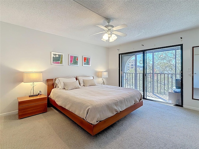 bedroom with access to exterior, a textured ceiling, baseboards, and carpet