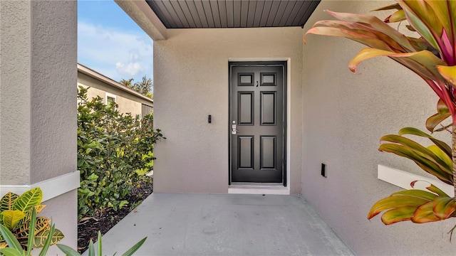 doorway to property with stucco siding