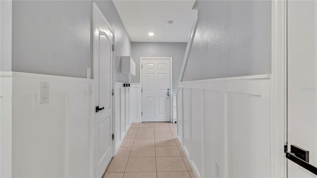 hall with light tile patterned floors and recessed lighting