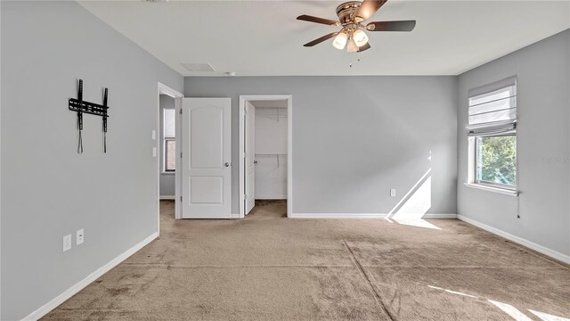 interior space featuring baseboards and ceiling fan