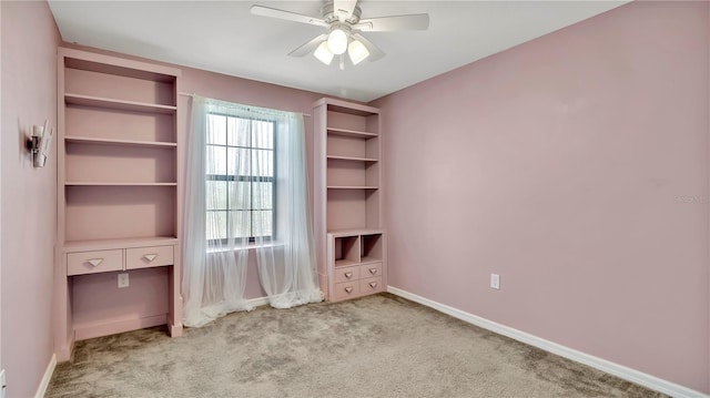 unfurnished bedroom featuring carpet flooring, a ceiling fan, and baseboards