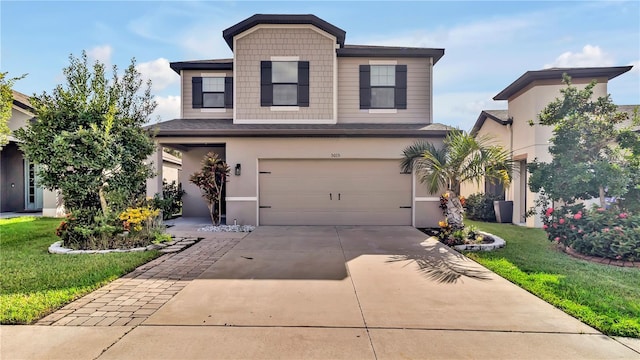 view of front of property featuring a garage, concrete driveway, a front lawn, and stucco siding