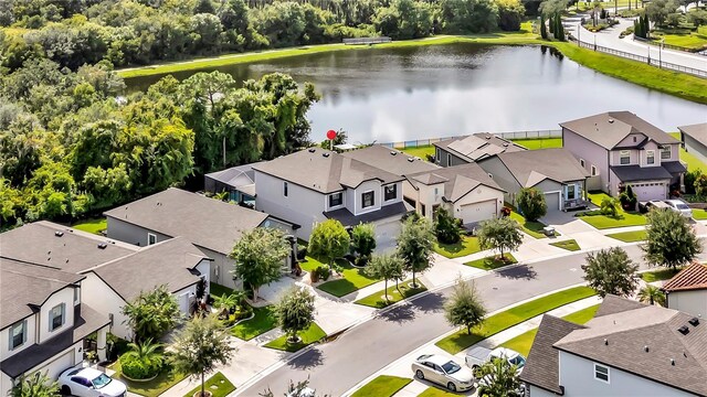 drone / aerial view with a residential view and a water view