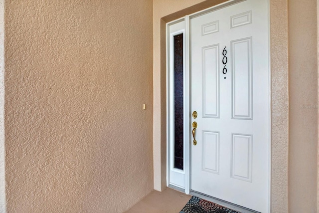 doorway to property with stucco siding