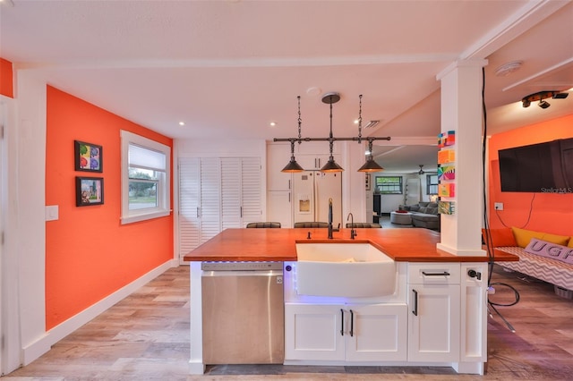 5601 2nd Ave N, Saint Petersburg, FL 33710 - kitchen with open floor plan, white cabinetry, a sink, light wood-type flooring, and dishwasher