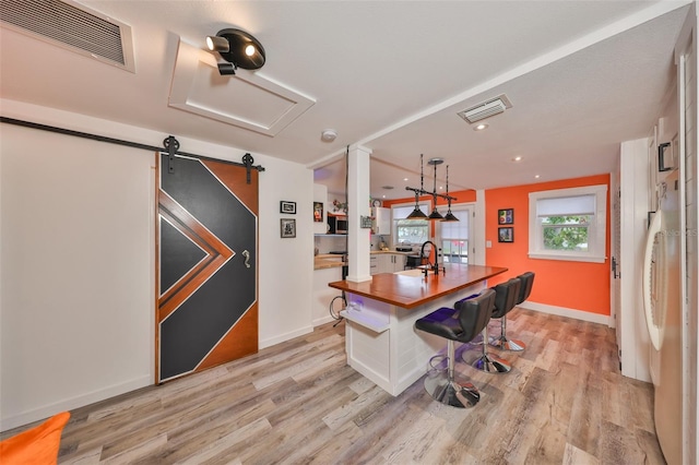 5601 2nd Ave N, Saint Petersburg, FL 33710 - office with visible vents, light wood-style flooring, and a barn door