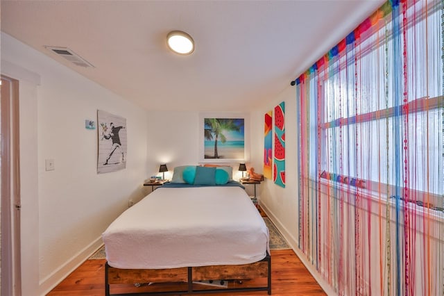5601 2nd Ave N, Saint Petersburg, FL 33710 - bedroom with wood finished floors, visible vents, and baseboards