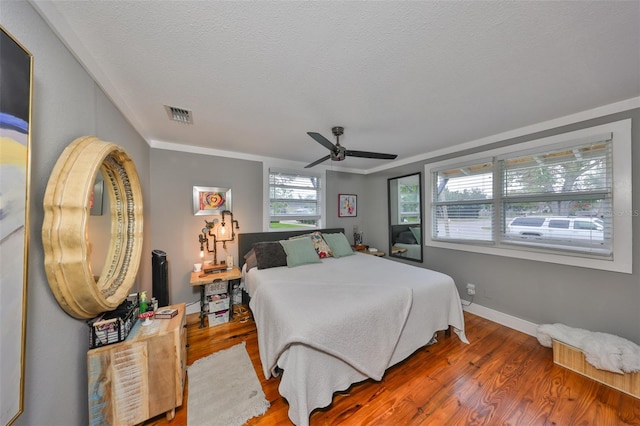 5601 2nd Ave N, Saint Petersburg, FL 33710 - bedroom with baseboards, visible vents, a ceiling fan, wood finished floors, and a textured ceiling