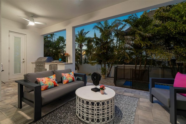 view of patio featuring a ceiling fan, a fenced backyard, a grill, exterior kitchen, and outdoor lounge area