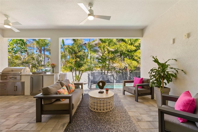 sunroom / solarium featuring a ceiling fan