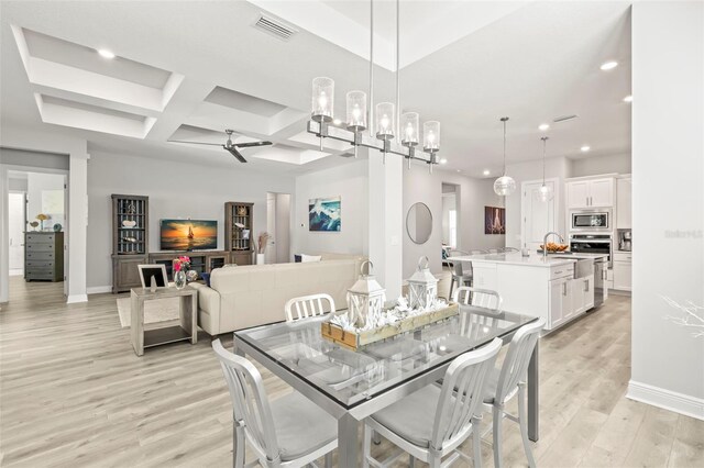 dining area featuring light wood-type flooring, visible vents, baseboards, and recessed lighting