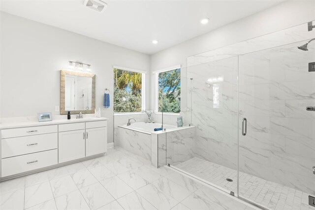 bathroom with marble finish floor, a marble finish shower, visible vents, vanity, and a bath