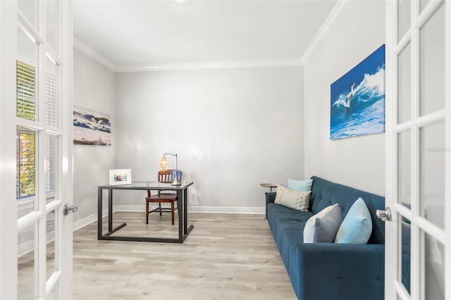 office space with french doors, crown molding, and light wood finished floors