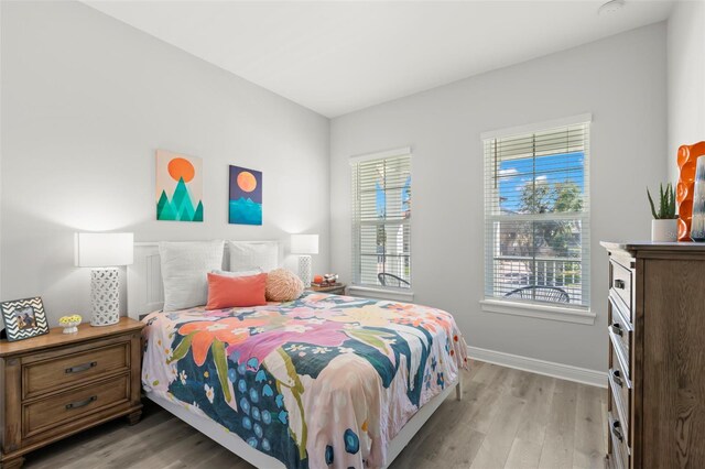 bedroom featuring light wood-type flooring and baseboards