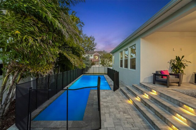 view of swimming pool featuring a patio area, a fenced backyard, and a fenced in pool