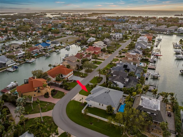 bird's eye view featuring a water view and a residential view