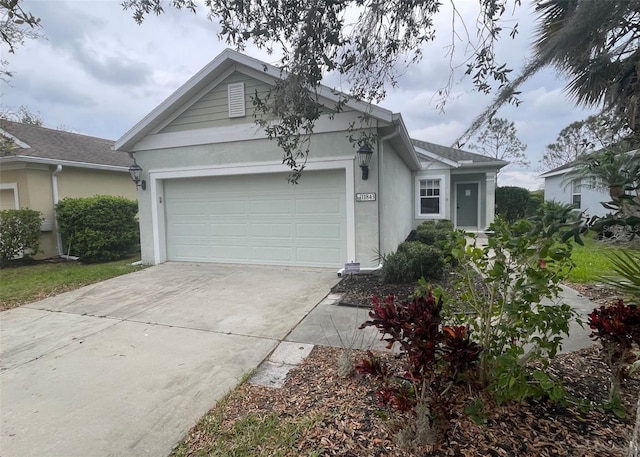 view of front of property featuring a garage, driveway, and stucco siding