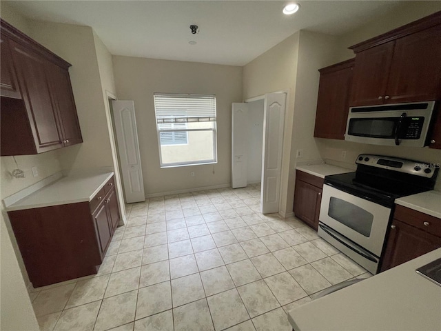 kitchen with light tile patterned floors, stainless steel appliances, recessed lighting, light countertops, and baseboards