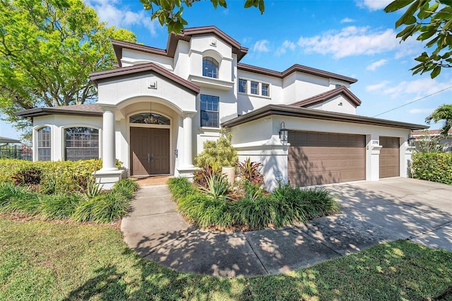 mediterranean / spanish-style home with concrete driveway and stucco siding