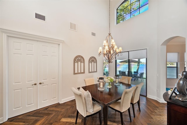 dining space featuring plenty of natural light, visible vents, and arched walkways