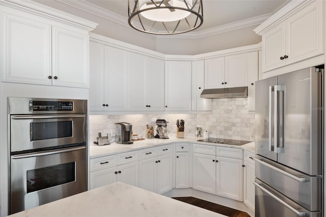 kitchen with under cabinet range hood, stainless steel appliances, light countertops, ornamental molding, and tasteful backsplash