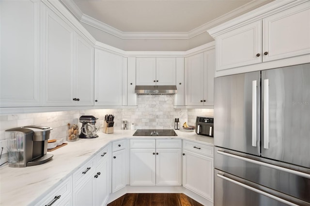 kitchen featuring tasteful backsplash, stainless steel refrigerator, white cabinets, under cabinet range hood, and black electric cooktop