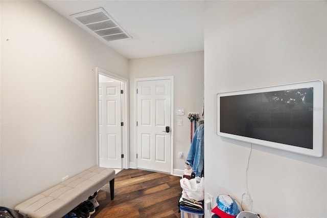 interior space with wood finished floors and visible vents