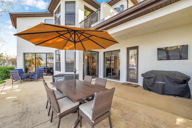 view of patio / terrace with outdoor dining area, a balcony, and area for grilling