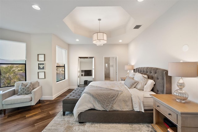 bedroom featuring recessed lighting, a raised ceiling, visible vents, and dark wood finished floors