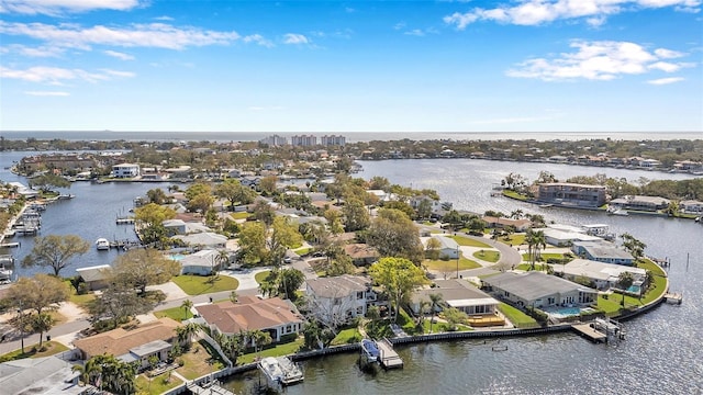 birds eye view of property with a water view and a residential view