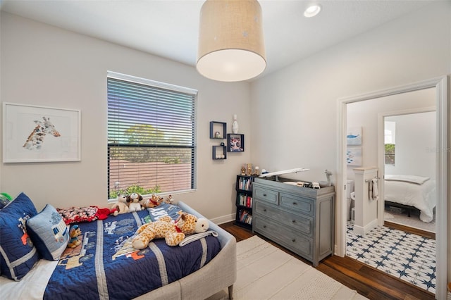 bedroom featuring baseboards and wood finished floors