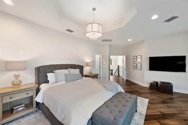 bedroom with visible vents, wood finished floors, and recessed lighting