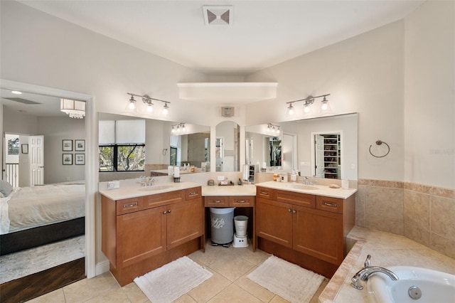 ensuite bathroom with visible vents, a tub, ensuite bath, tile patterned floors, and vanity