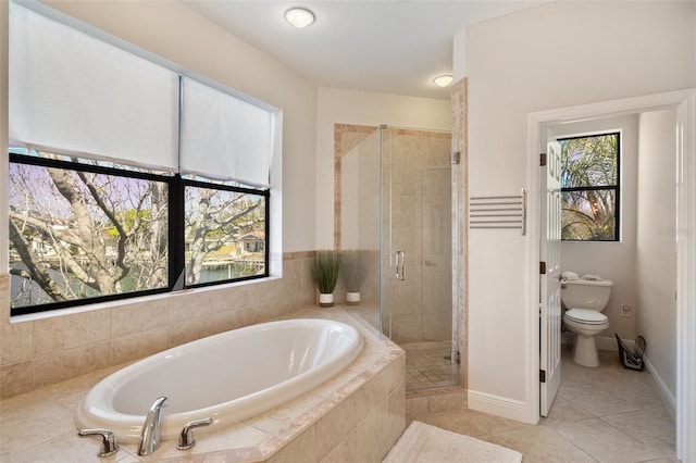 full bathroom with toilet, baseboards, a shower stall, a bath, and tile patterned floors